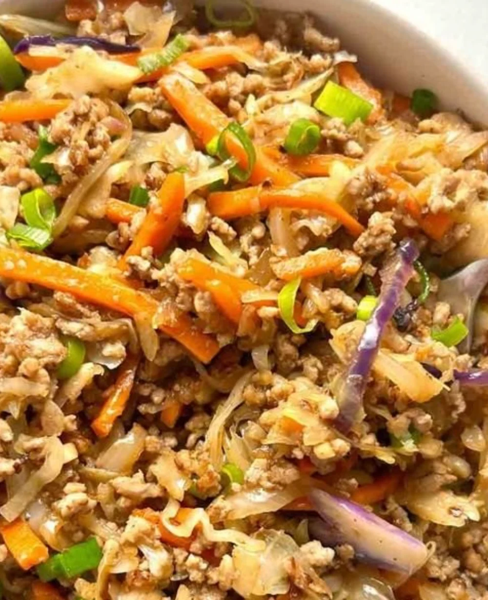 Cozy egg roll in a bowl topped with fresh ingredients for a comforting meal.