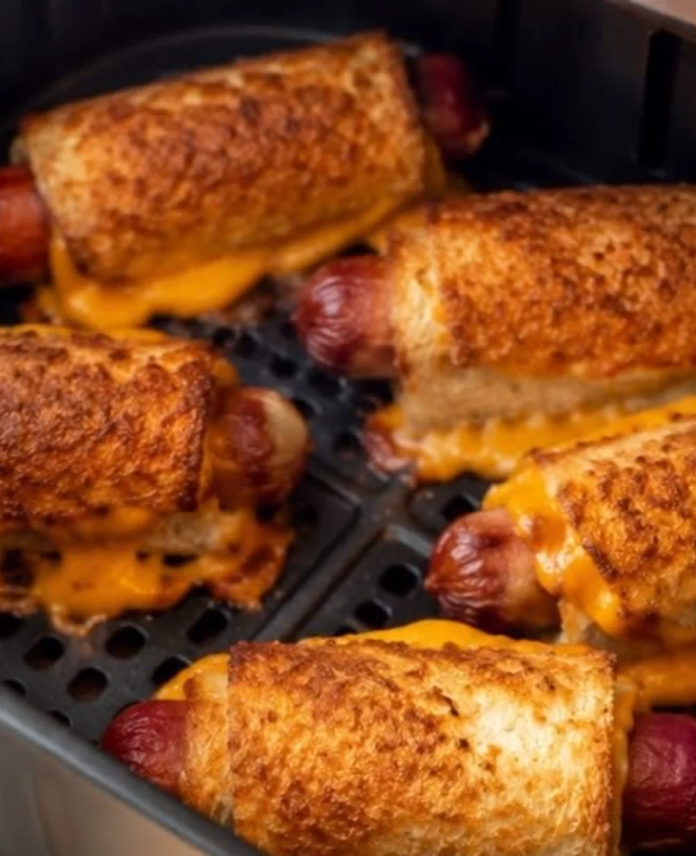 Air fryer grilled cheese hot dogs served on a plate with crispy edges.