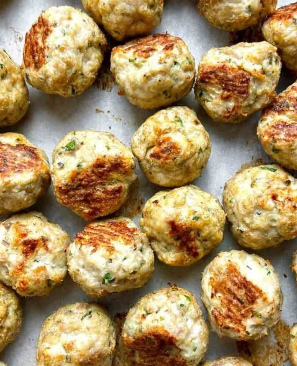 Baked turkey meatballs served with marinara sauce and herbs.