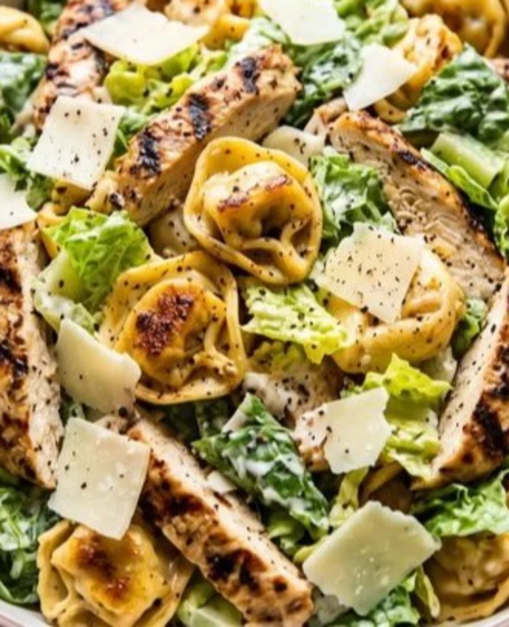 Delicious Blackstone Chicken Caesar Tortellini served in a bowl, garnished with parmesan