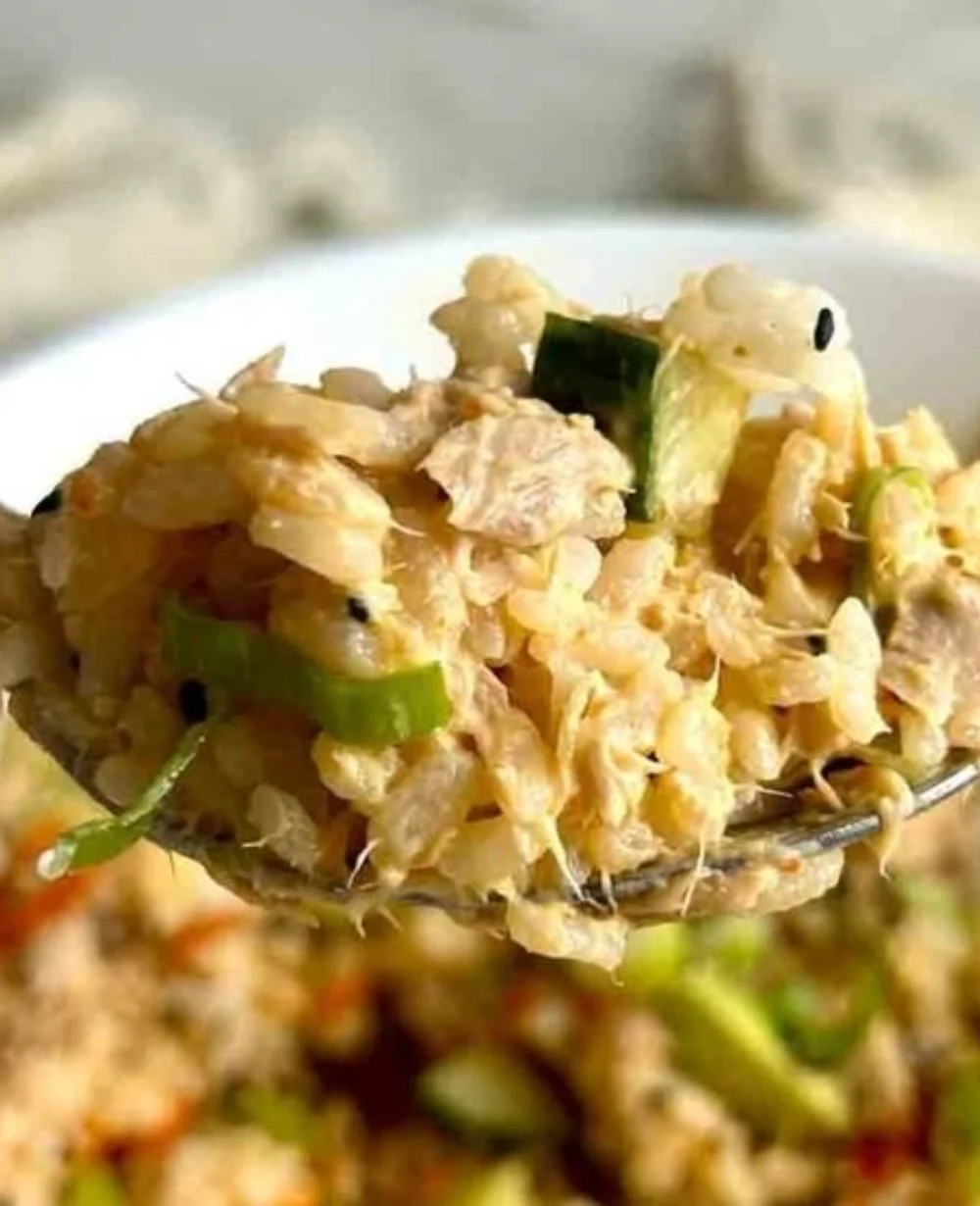 Canned tuna rice bowl with vegetables and toppings for a healthy meal