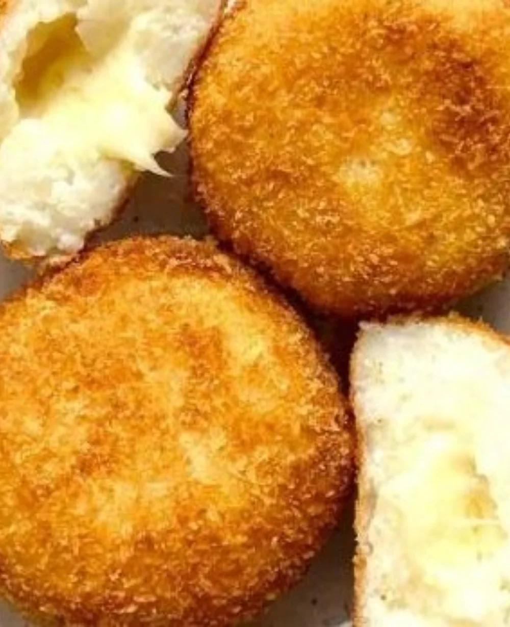 Delicious golden brown cheese croquettes served on a plate