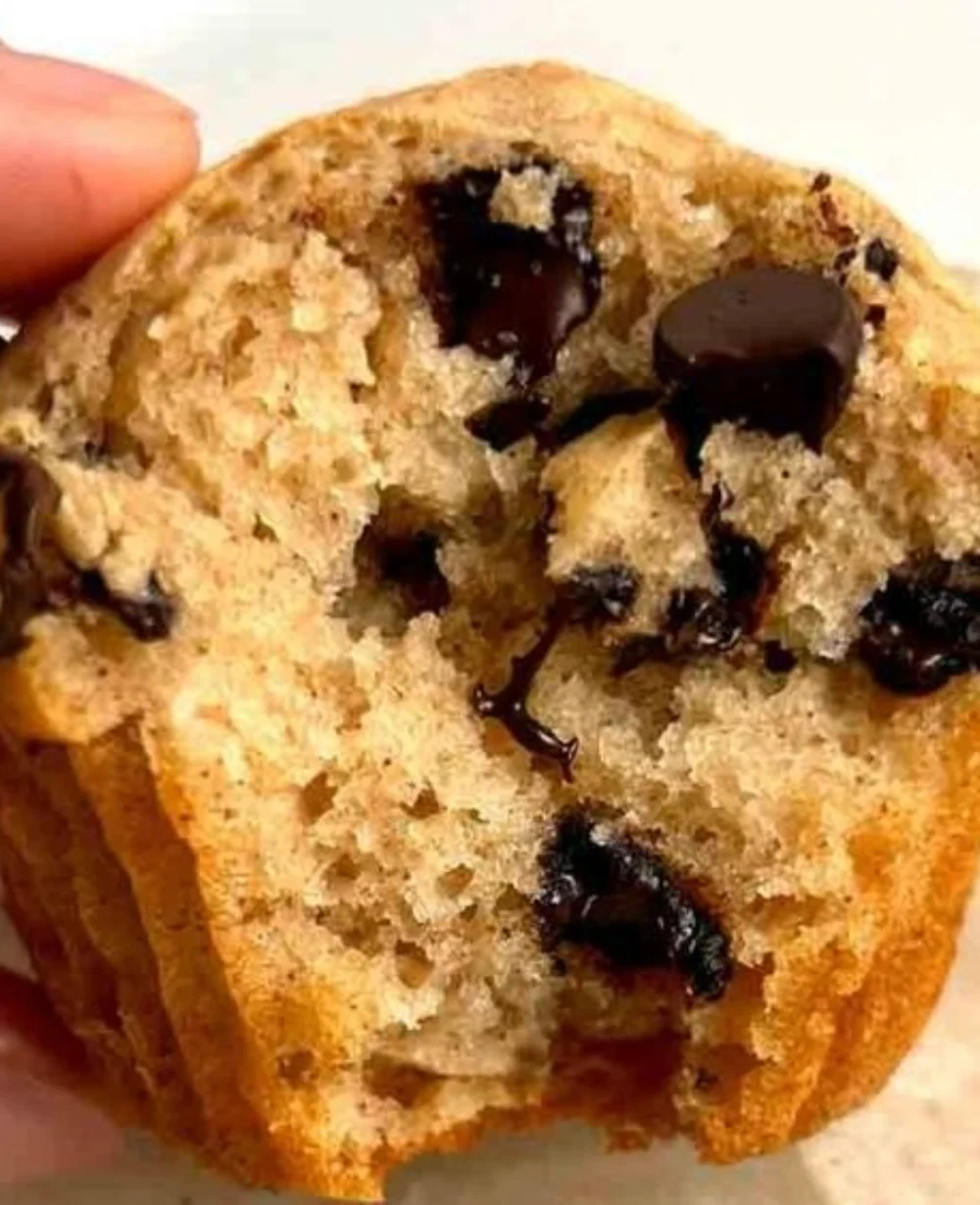 Freshly baked chocolate chip muffins on a cooling rack
