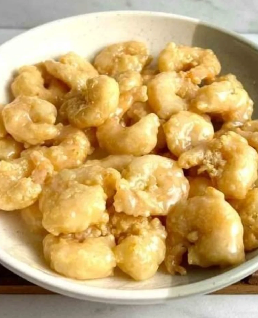 Plate of crispy Coconut Shrimp served with a tangy dipping sauce