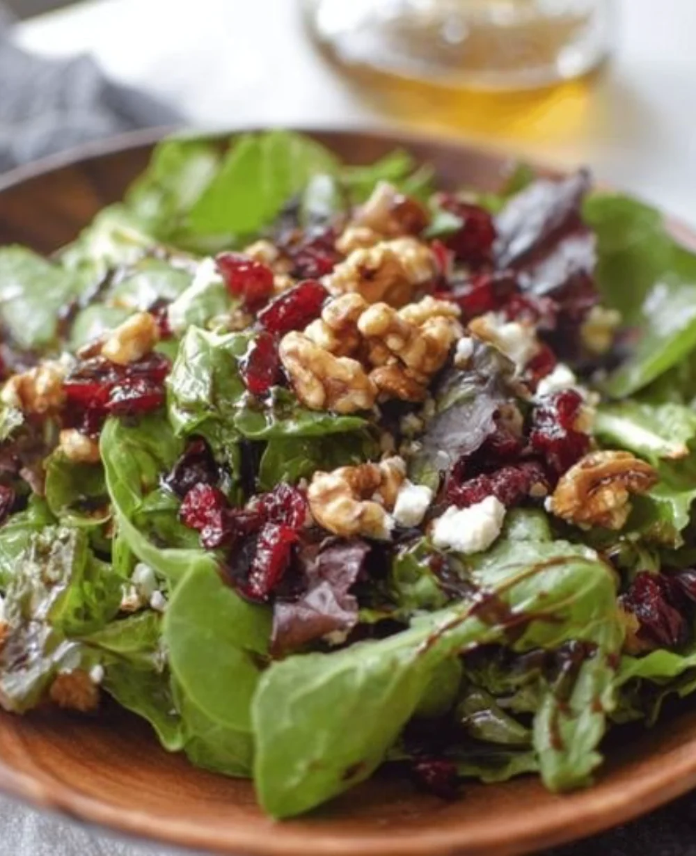 Cranberry Walnut Goat Cheese Salad with fresh greens and vibrant toppings.