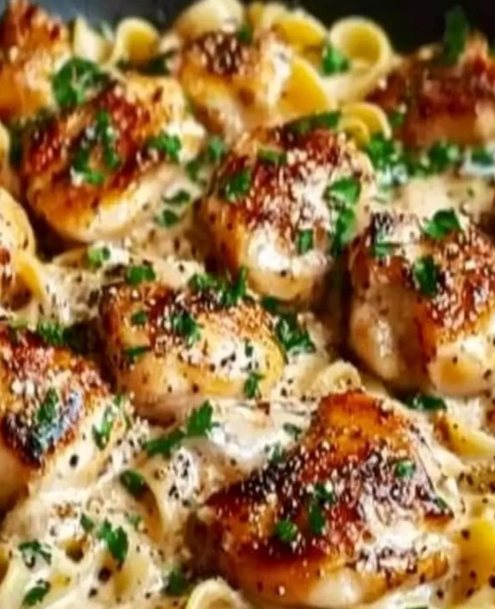 Creamy garlic butter chicken served over egg noodles in a bowl