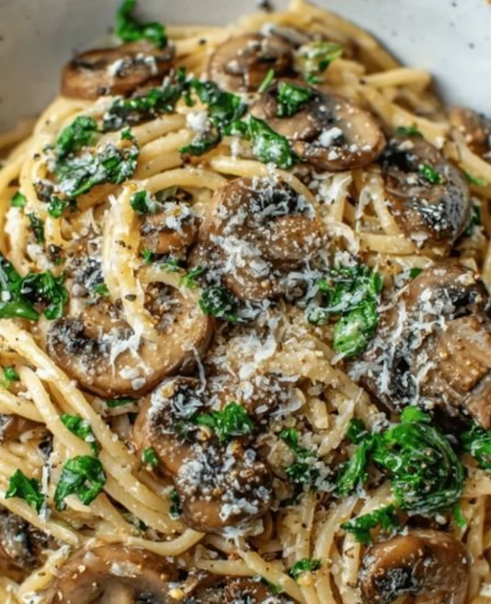 Creamy mushroom garlic butter pasta served in a bowl with herbs on top.