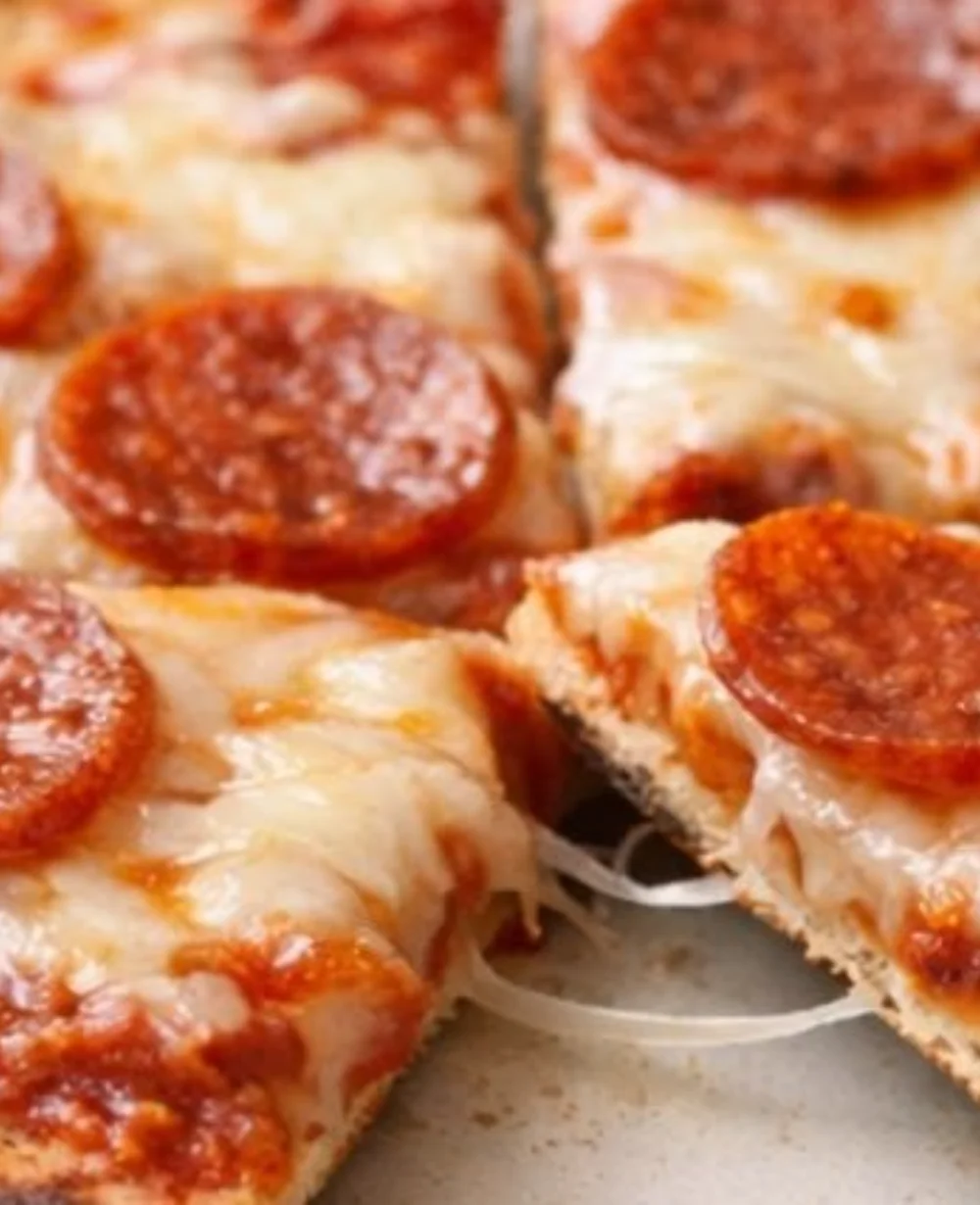 Crispy air fryer tortilla pizza topped with cheese and fresh ingredients.