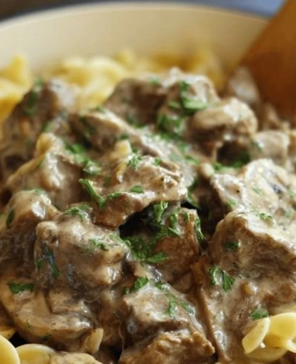 Bowl of Easy Crock Pot Beef Stroganoff with garnished herbs