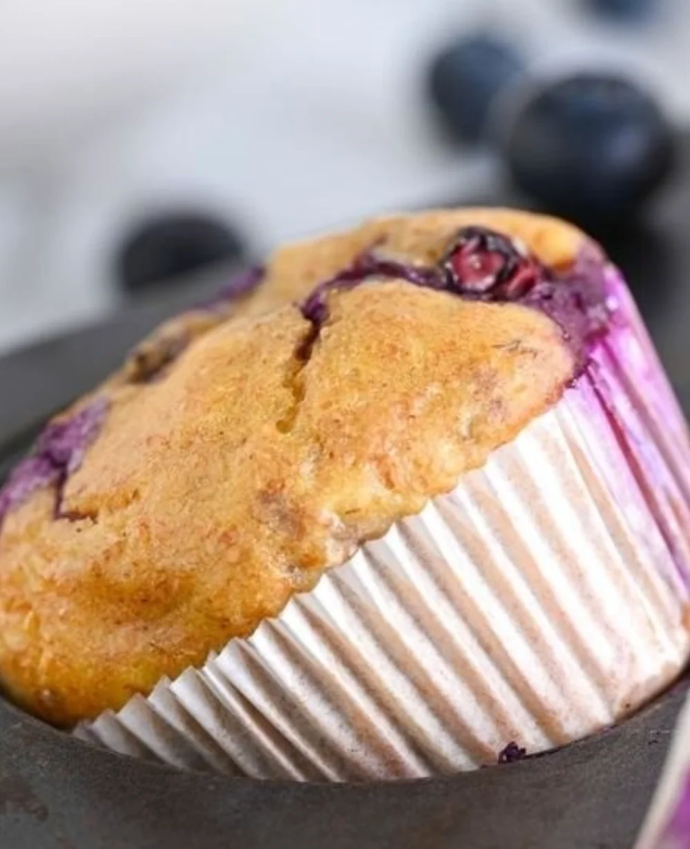 Freshly baked gluten-free blueberry muffins on a cooling rack