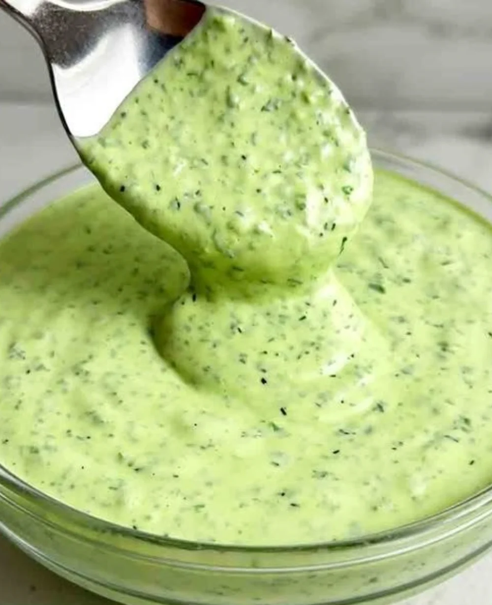 Creamy Green Goddess Dressing with fresh herbs in a bowl