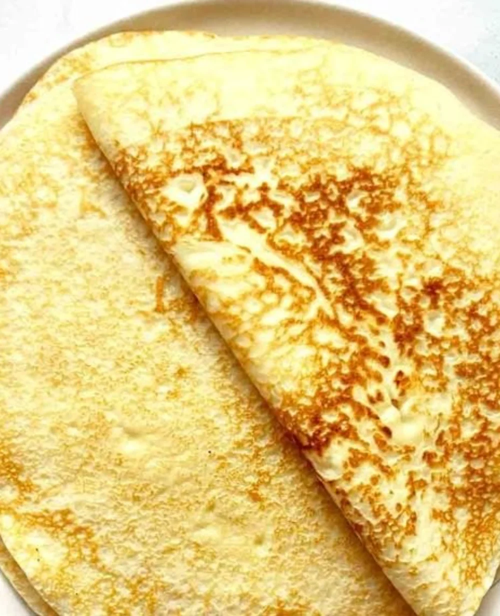 A plate of delicious homemade crepes filled with sweet and savory toppings.
