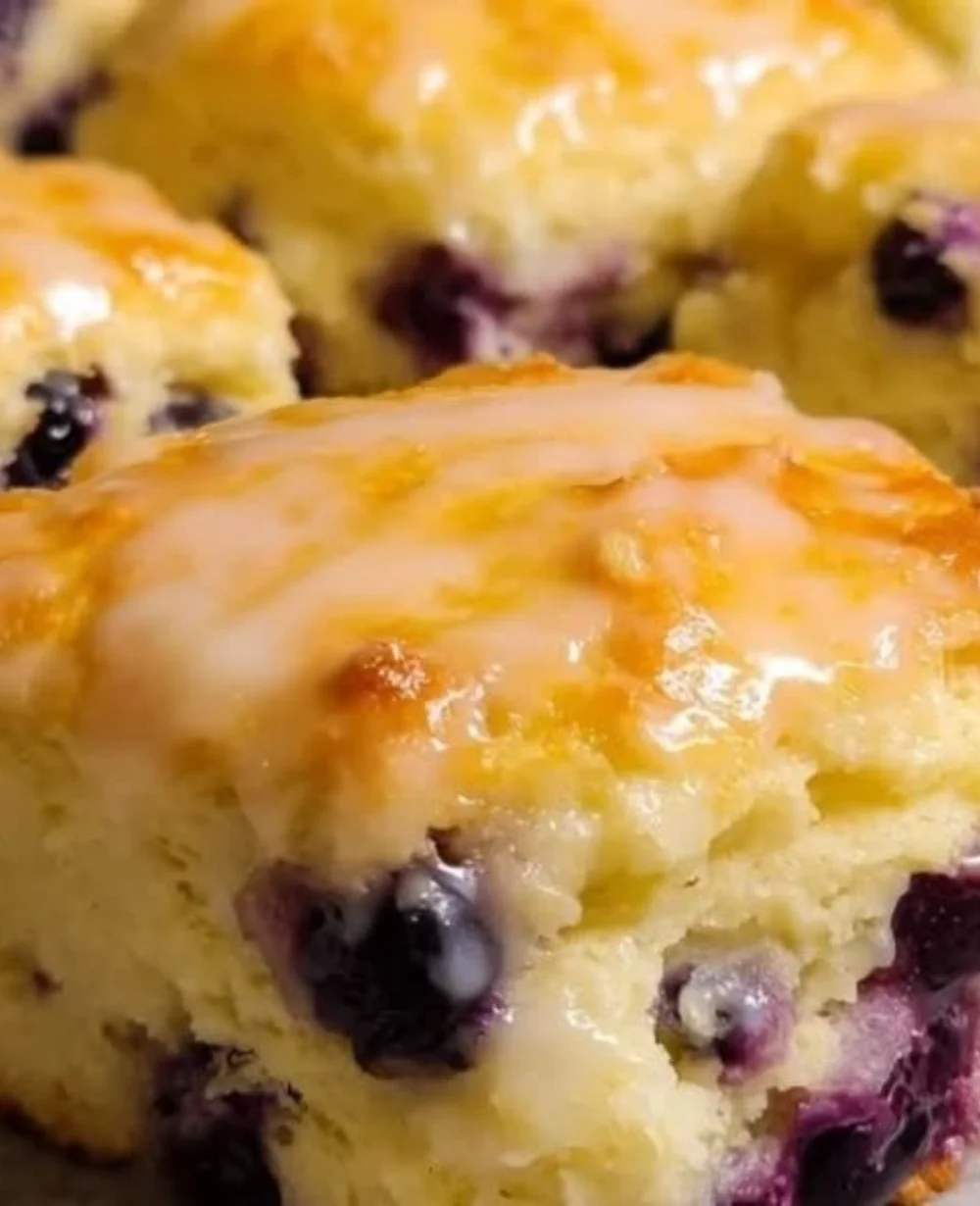 Freshly baked lemon blueberry butter swim biscuits on a cooling rack.