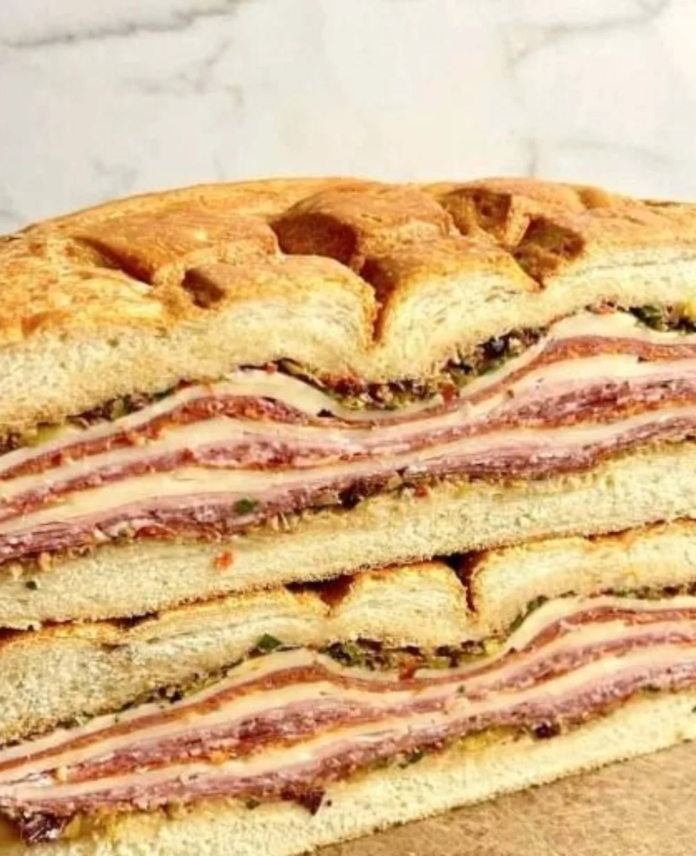 Delicious New Orleans muffuletta sandwich with olives and crusty bread