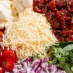 Colorful Sun Dried Tomato Pasta Salad with fresh ingredients and herbs