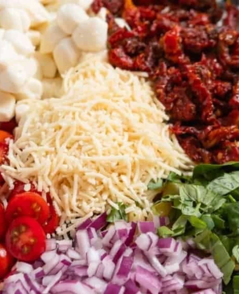 Colorful Sun Dried Tomato Pasta Salad with fresh ingredients and herbs