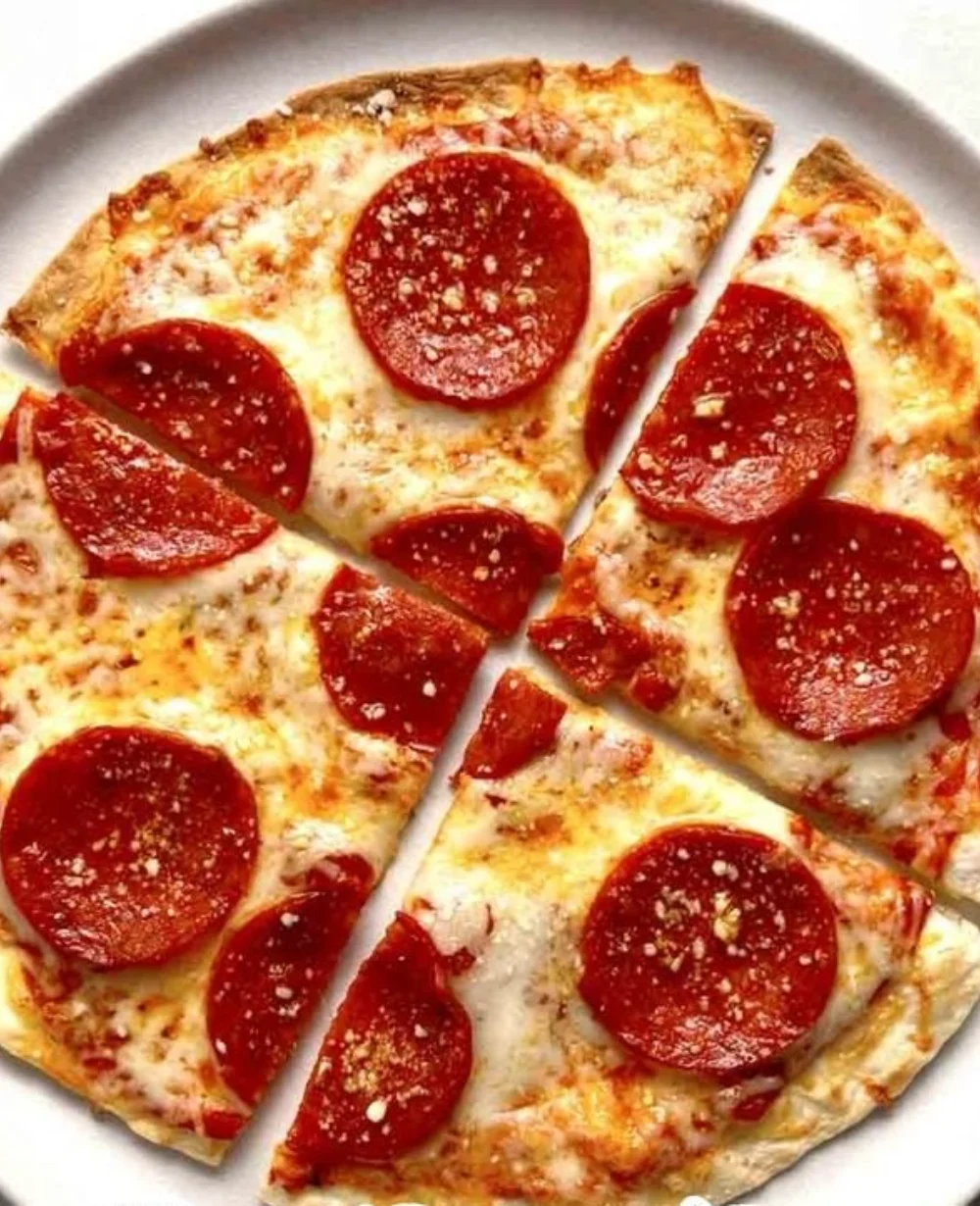 Delicious homemade tortilla pizza topped with fresh ingredients.
