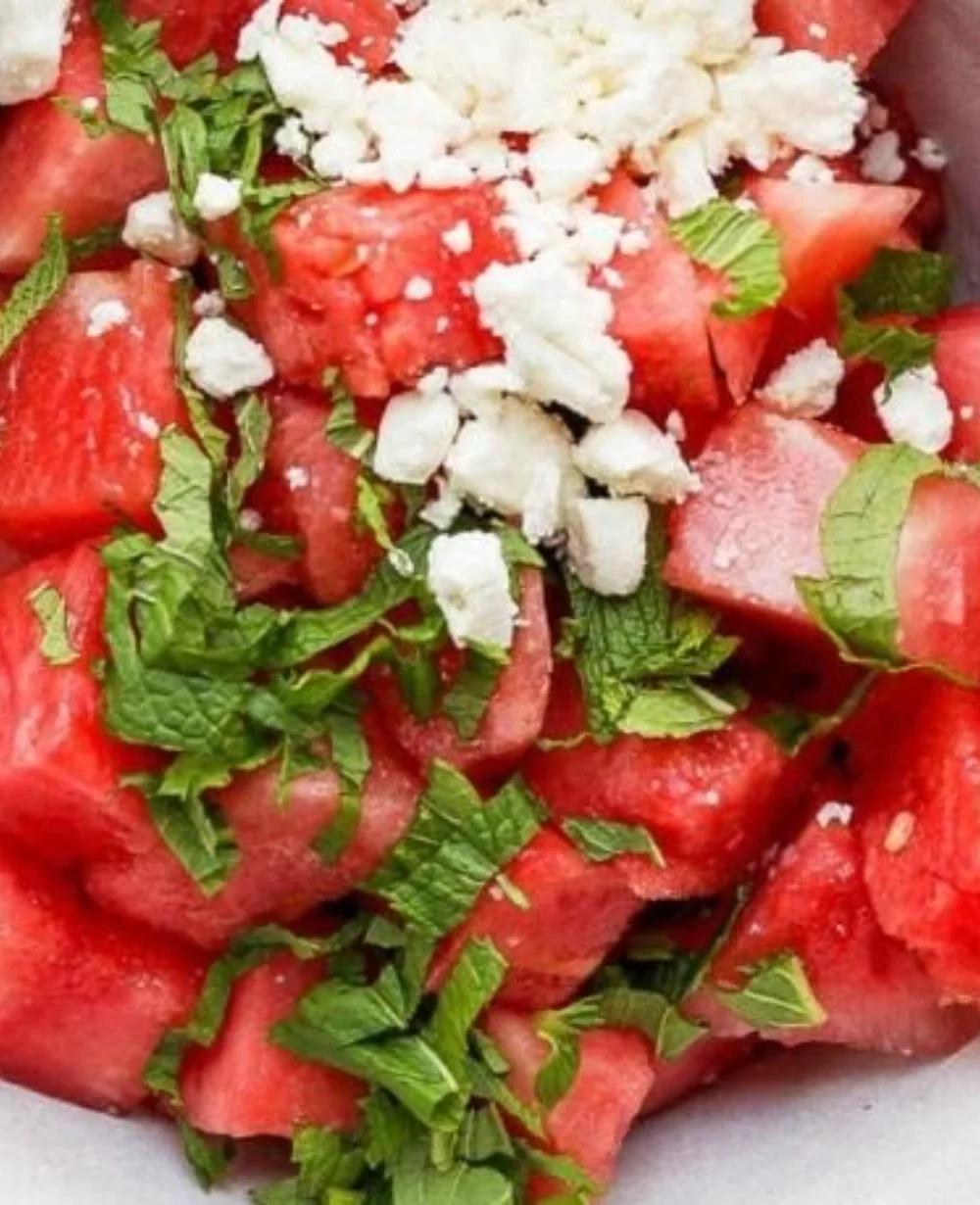 Fresh watermelon feta salad with mint on a plate, garnished beautifully.