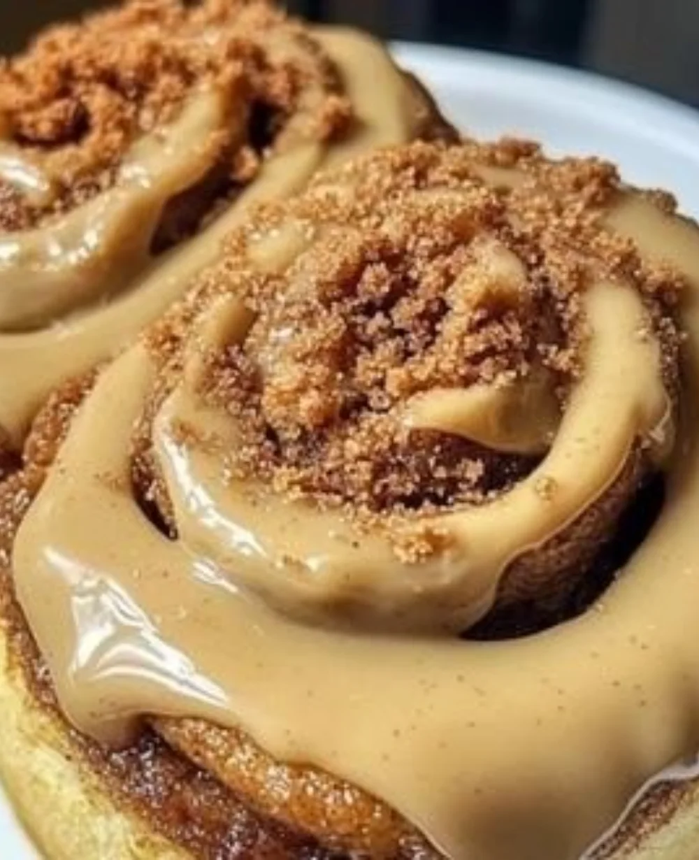 Biscoff cookie butter cinnamon rolls with creamy frosting and spices