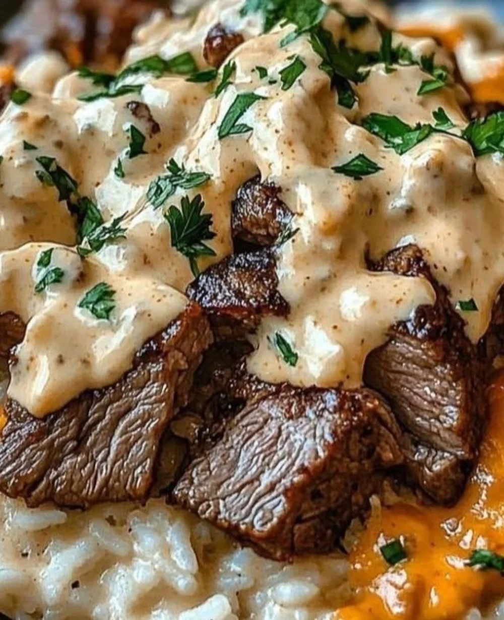 One-Pan Steak Queso Rice served in a skillet with melted cheese and fresh ingredients