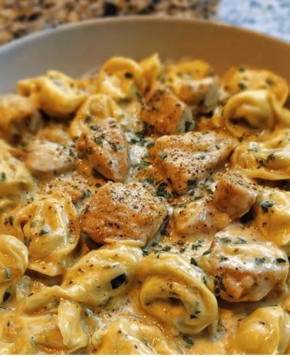 Cajun Garlic Chicken tortellini served in a creamy three-cheese sauce