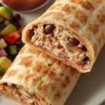 Delicious chicken bean burrito served with fresh toppings and salsa