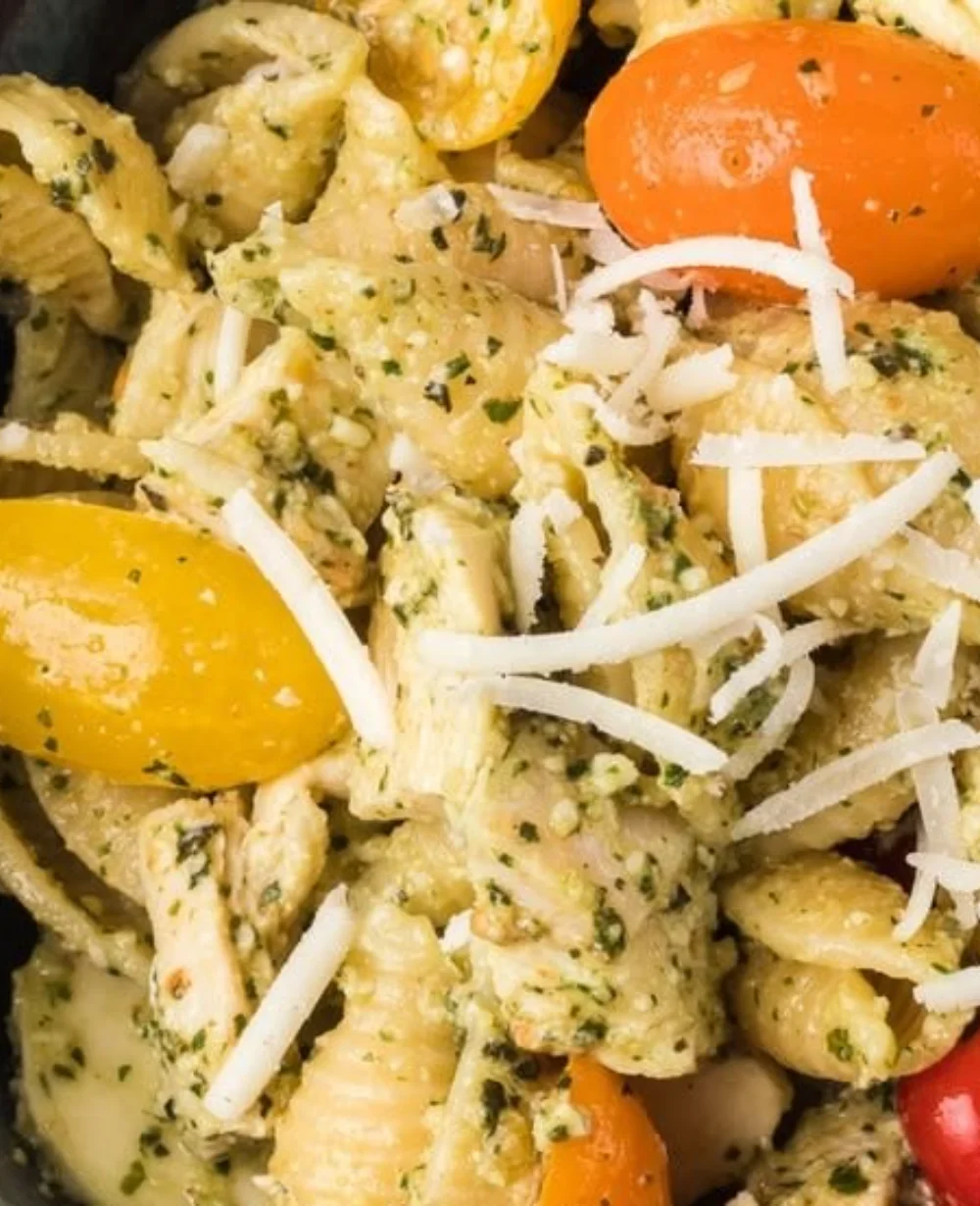 Healthy Chicken Pesto Pasta Salad with vegetables and herbs in a bowl