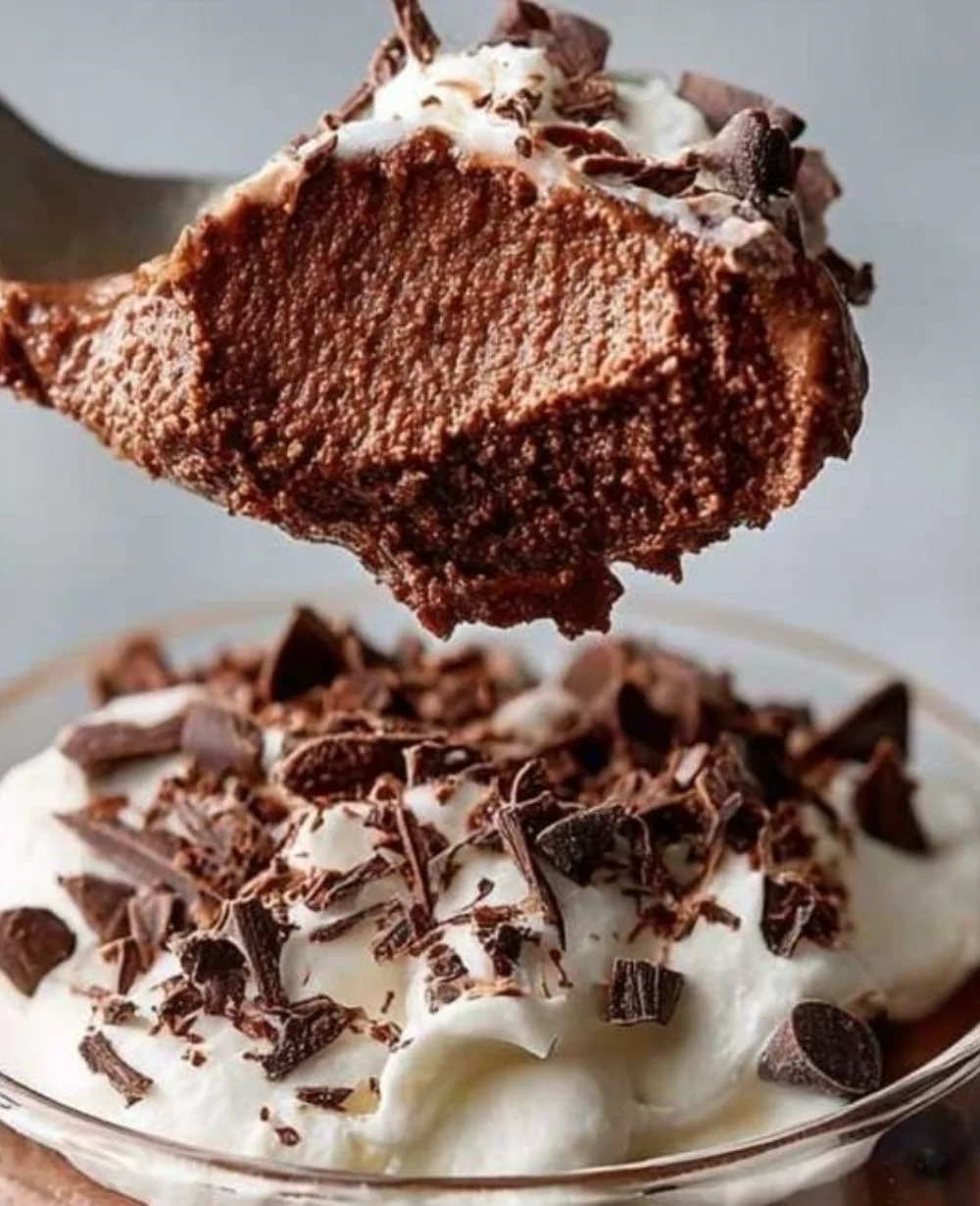 Delicious chocolate avocado pudding in a bowl topped with berries