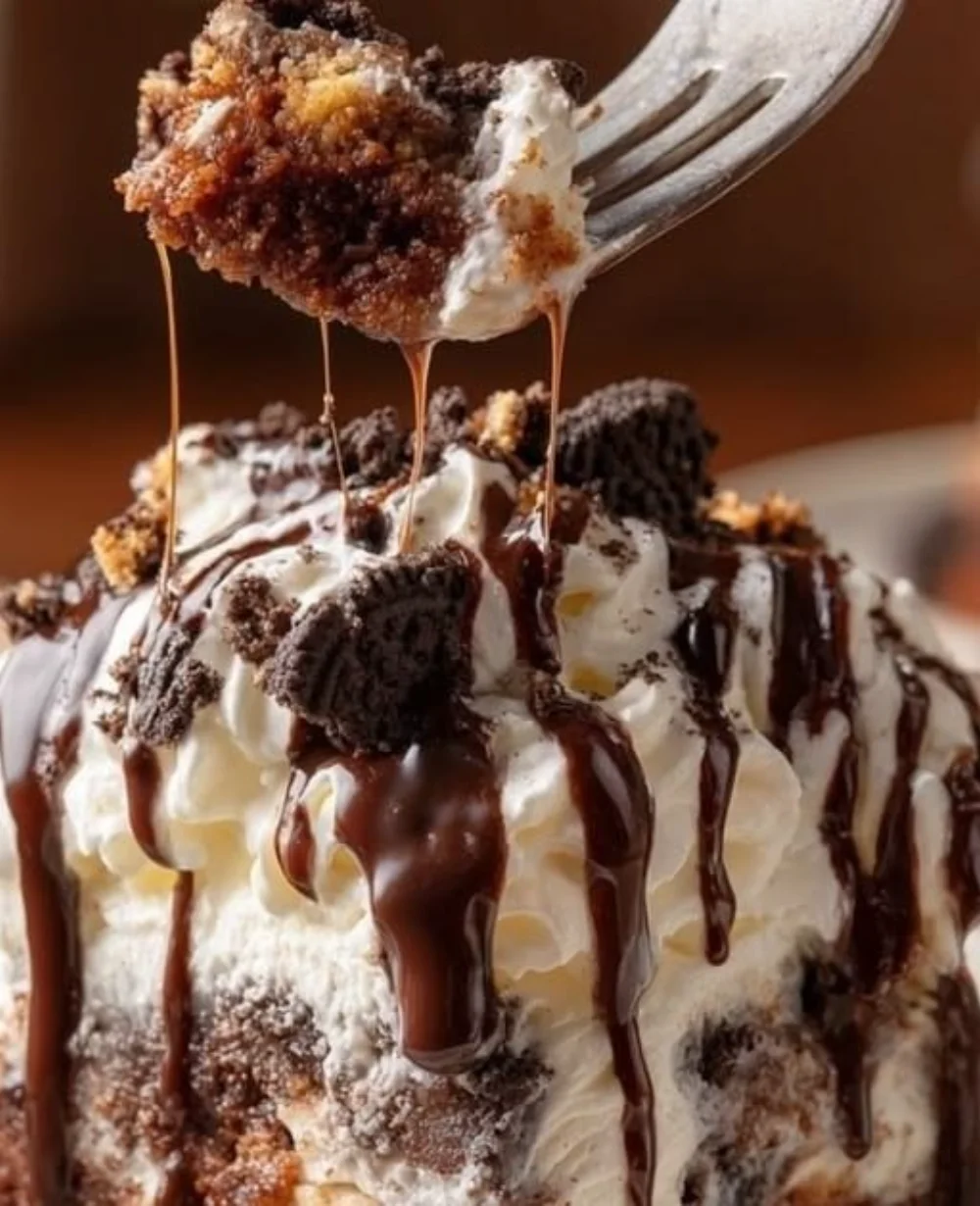 Delicious chocolate poke cake topped with condensed milk and chocolate drizzle