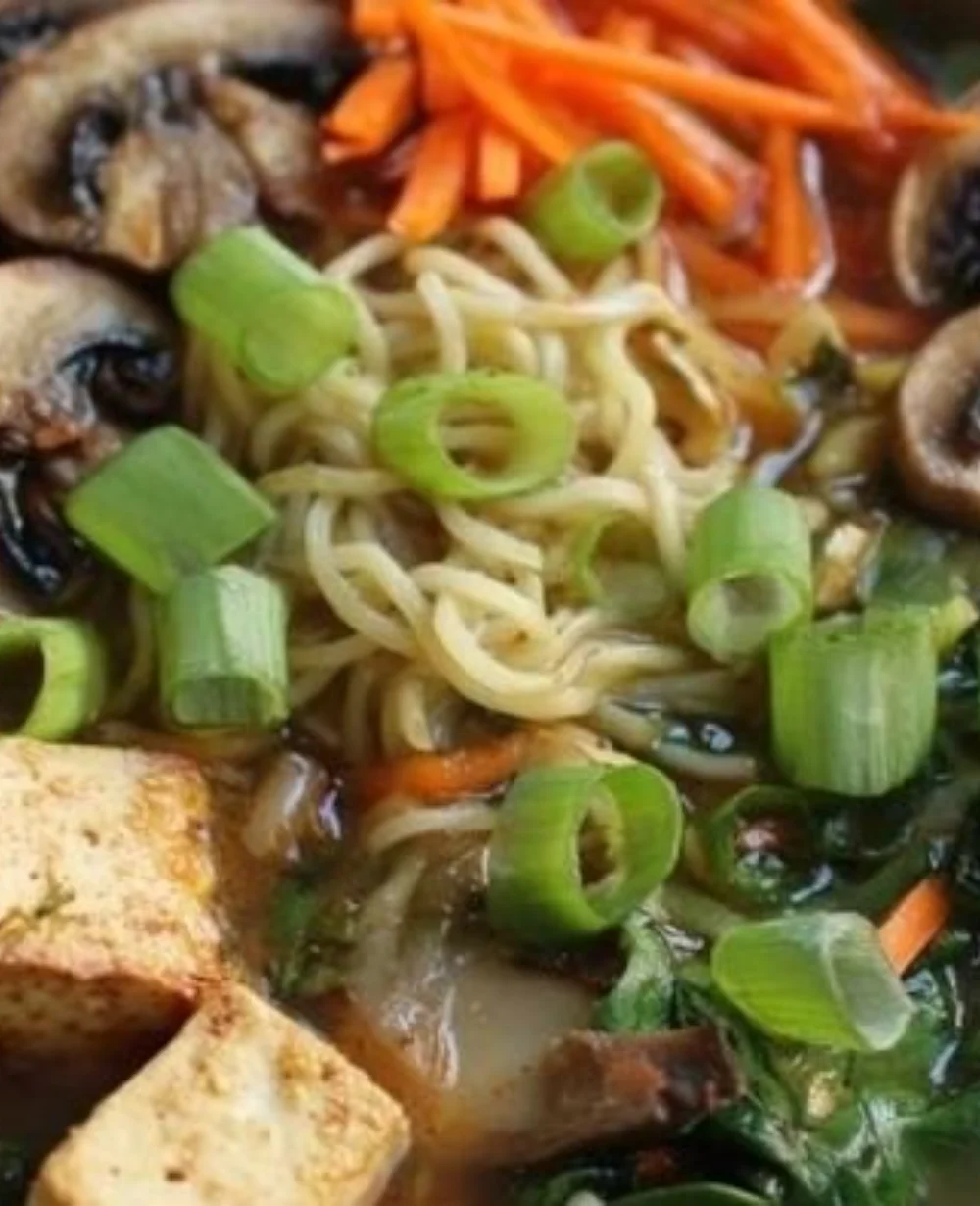 Bowl of comforting tofu ramen with fresh vegetables and broth