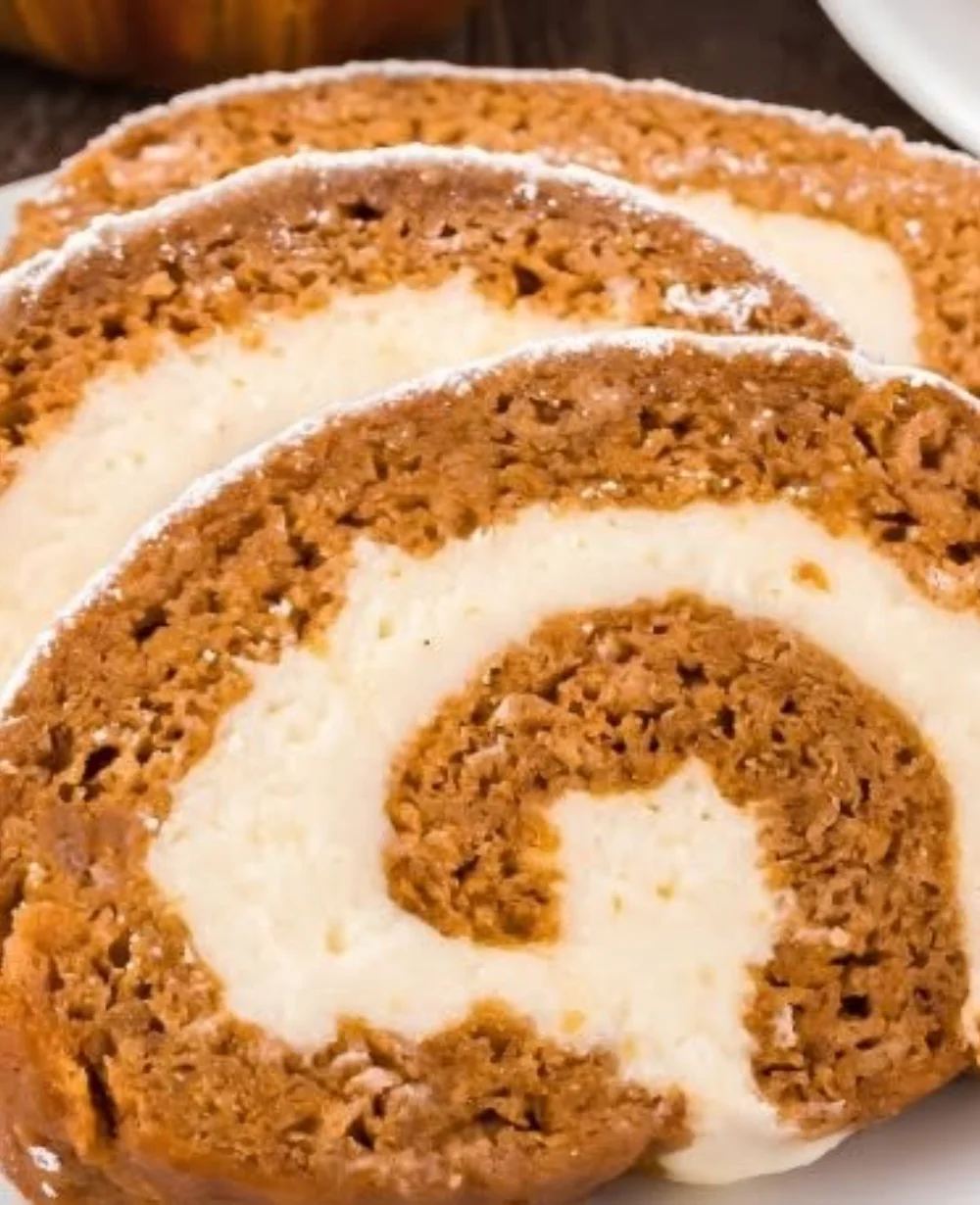 Cozy autumn pumpkin roll slice on a plate with fall decorations