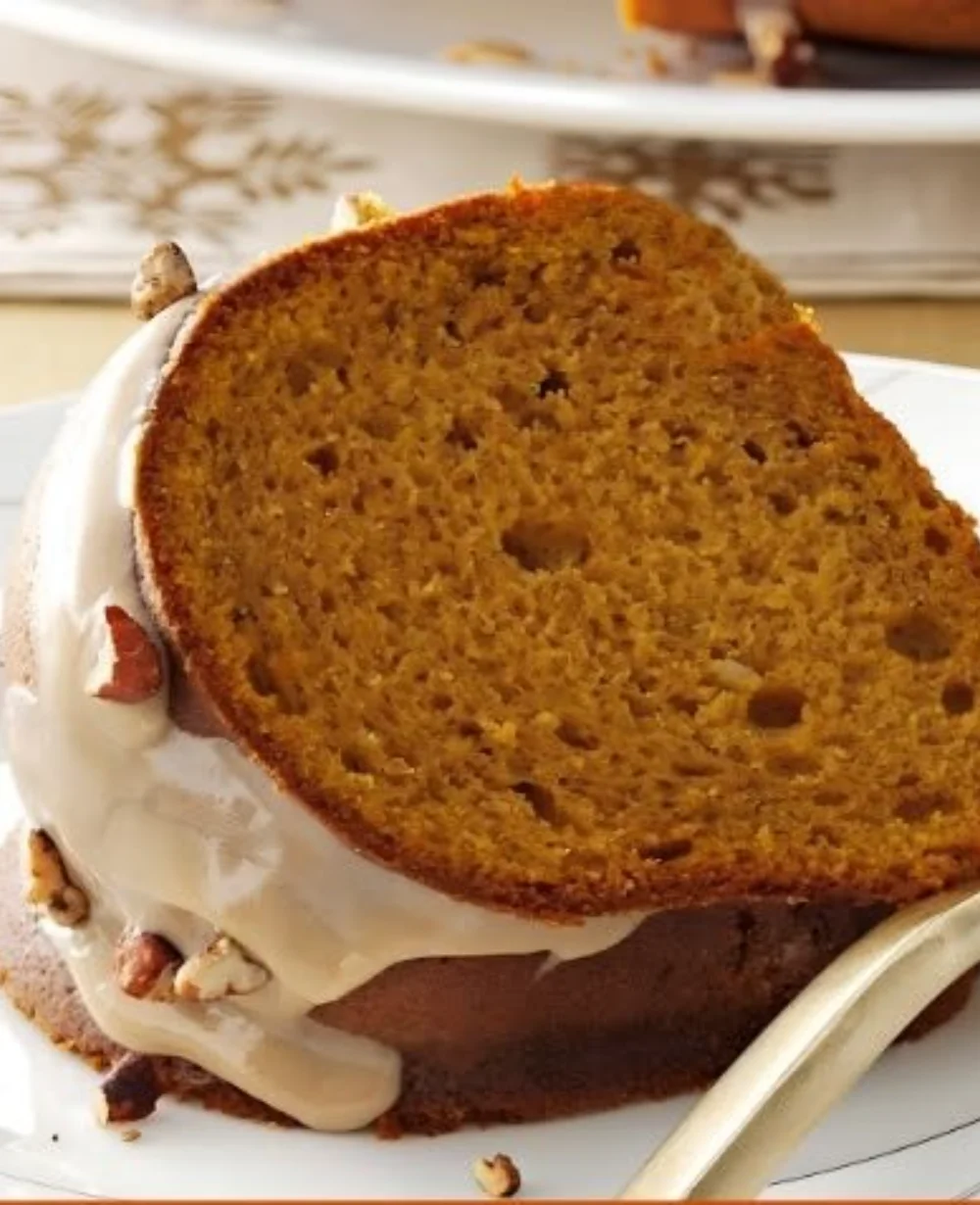 Deliciously moist pumpkin spice cake topped with cream cheese frosting and fall spices