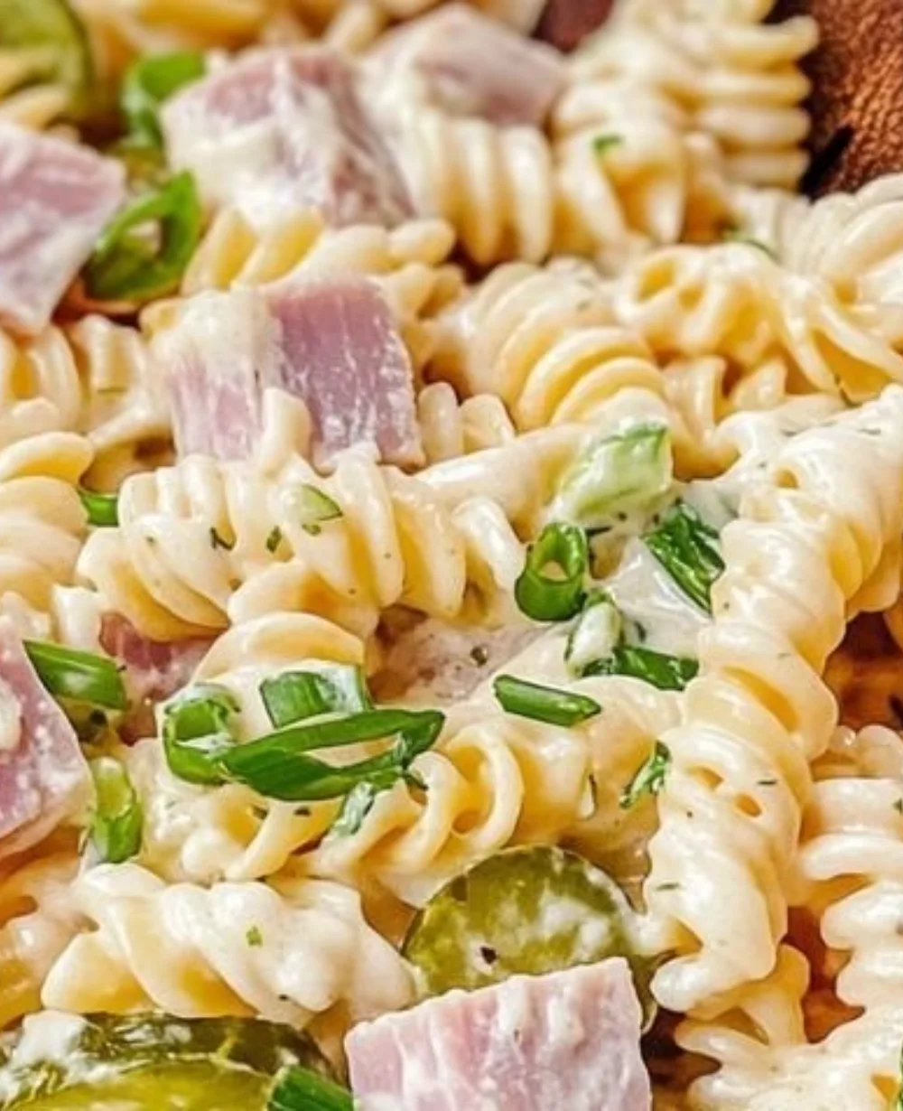 Creamy ham pickle pasta salad in a bowl, ideal for entertaining.