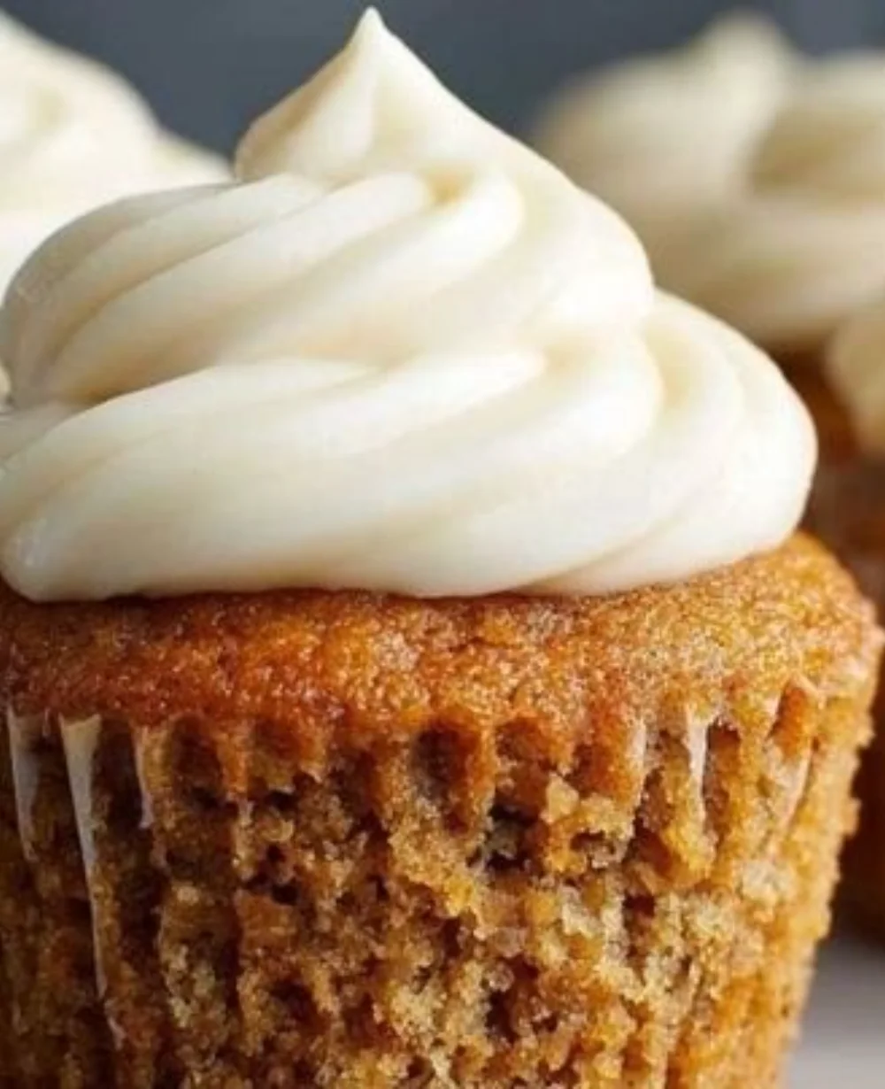 Delicious banana cupcakes with cream cheese frosting on a decorative plate