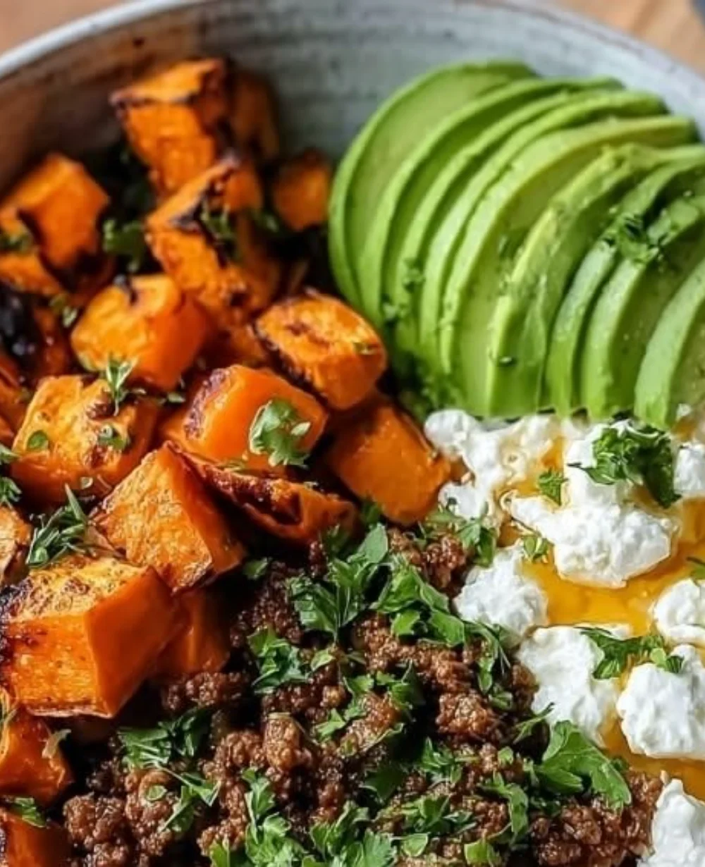Delicious ground beef hot honey bowl garnished with fresh herbs and spices.