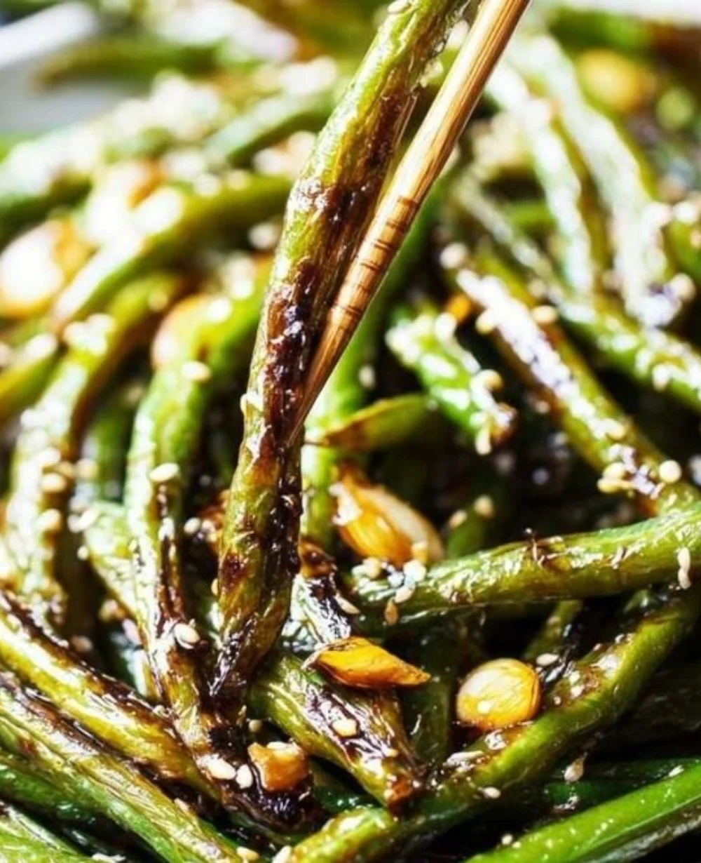Plate of vibrant pan-fried green beans with garlic and spices