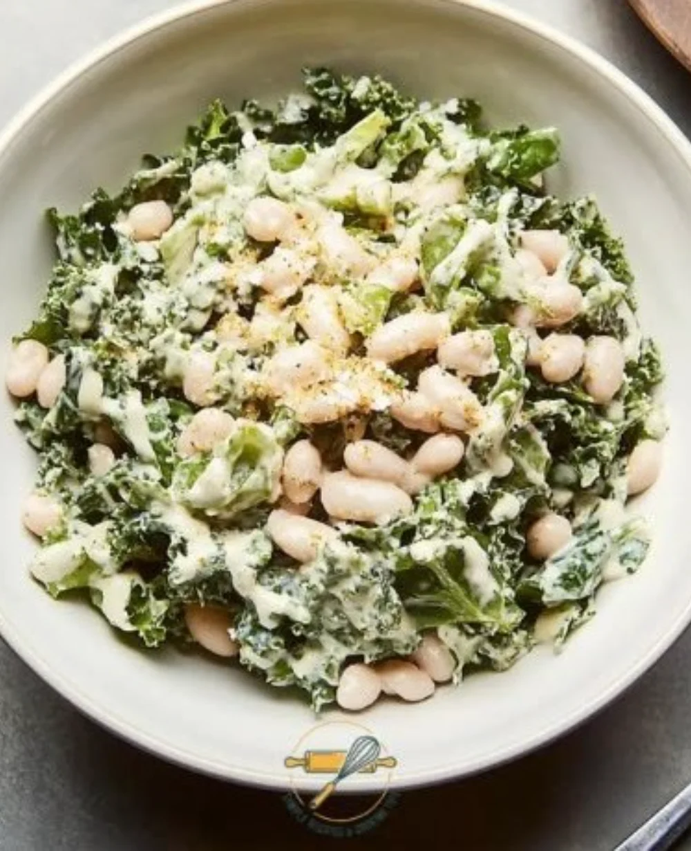 Lemon Tahini White Bean Caesar Salad served in a bowl with fresh greens and beans.