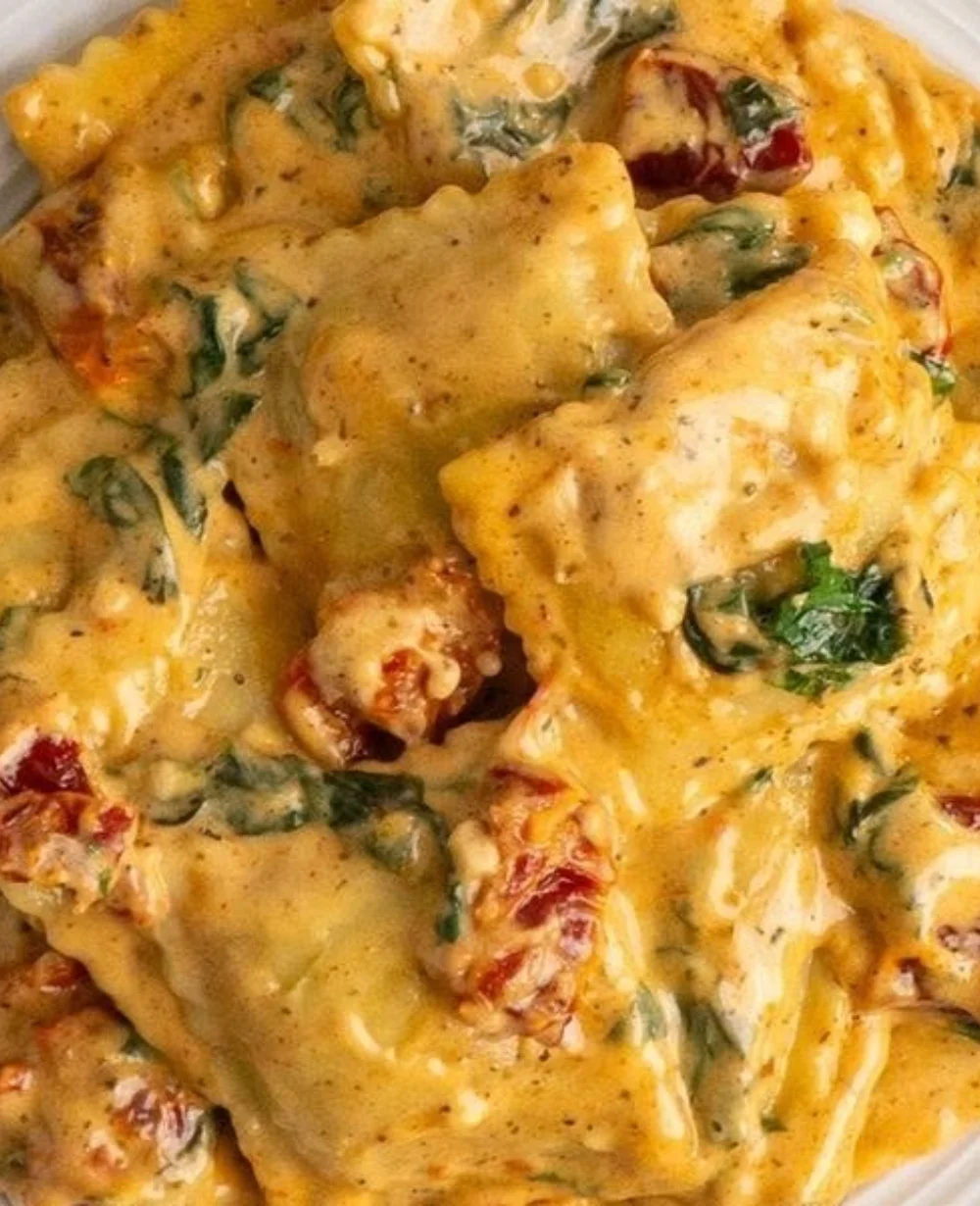 Plate of luscious Tuscan ravioli topped with fresh herbs and sauce