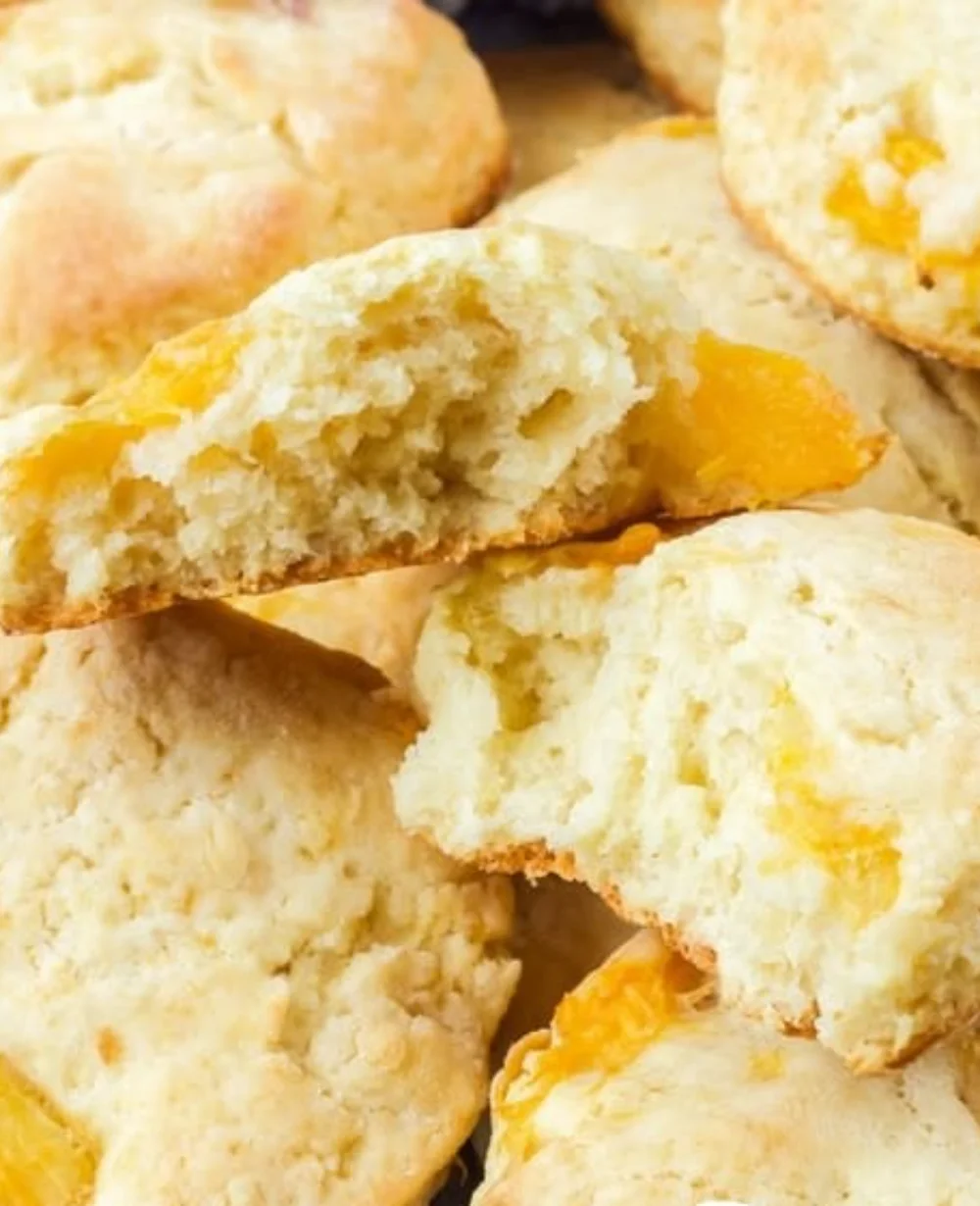 Freshly baked peach scones on a wooden table, ready to enjoy.