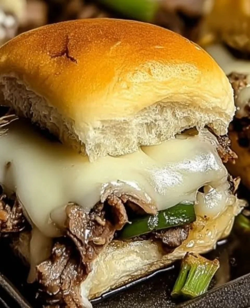 Philly Cheesesteak Sliders served on a platter with toppings