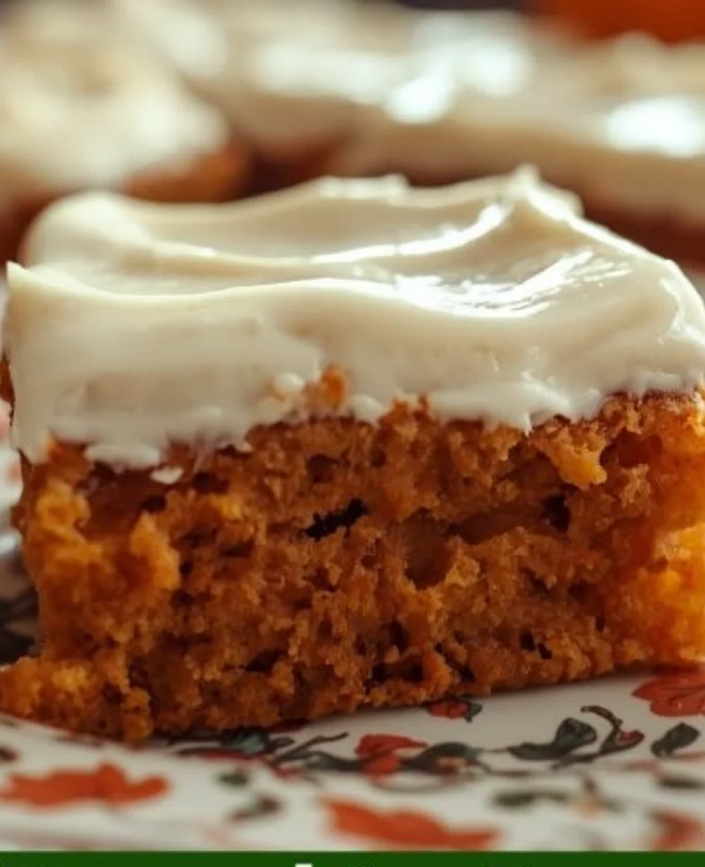 Delicious pumpkin bars with cream cheese frosting on a rustic background.
