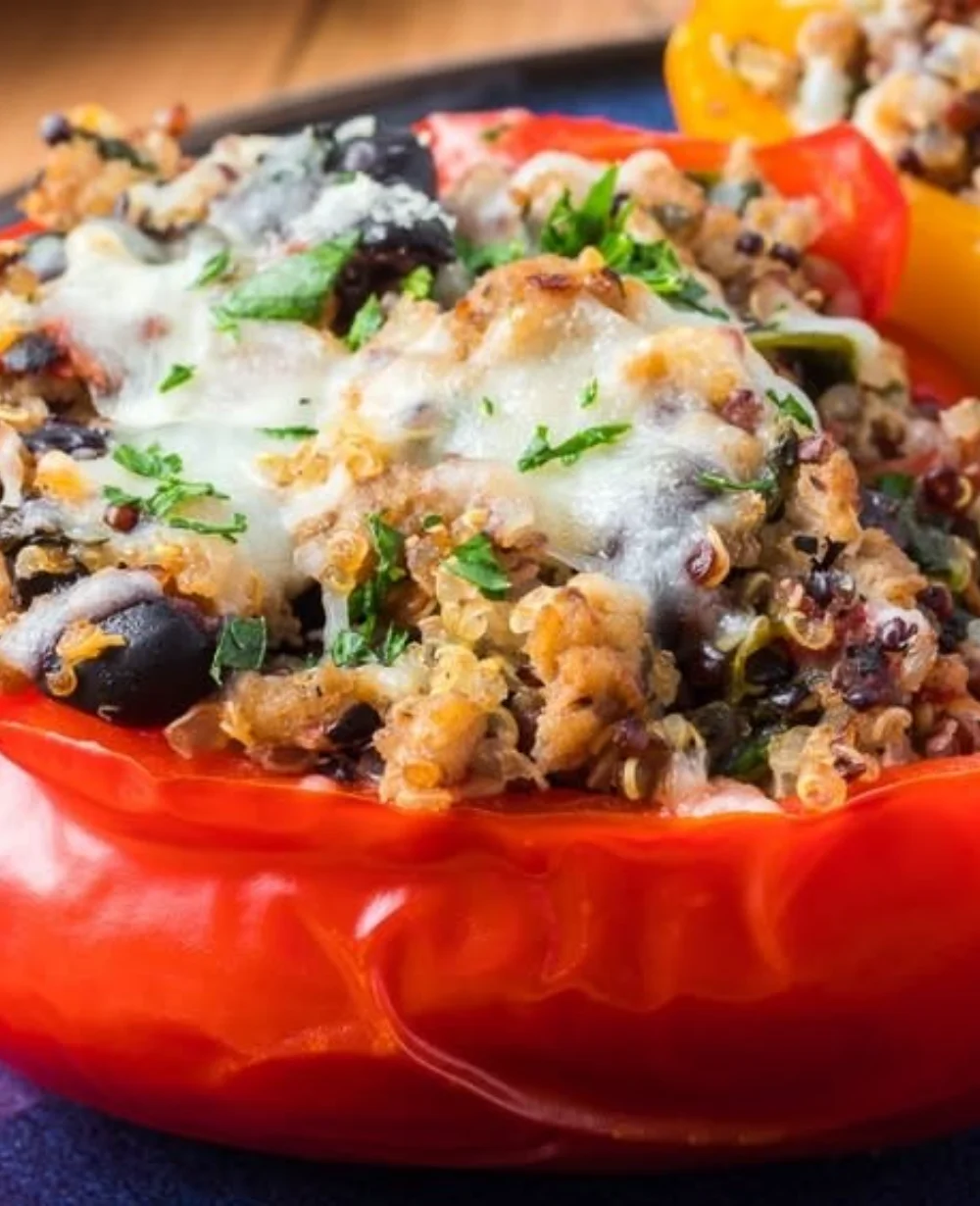 Quinoa, black bean, and turkey stuffed peppers served on a plate