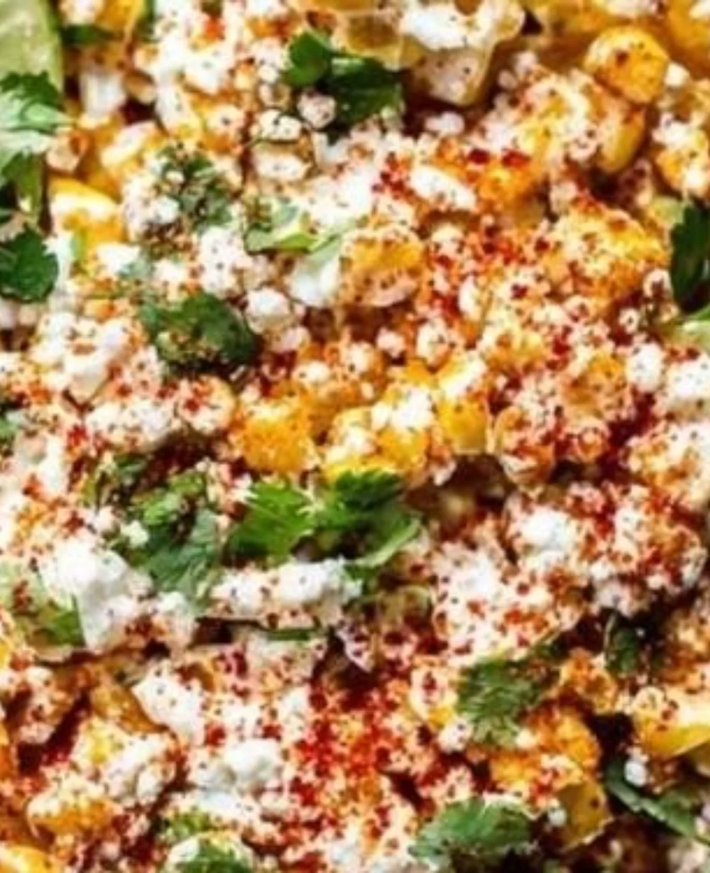 Delicious Mexican street corn topped with creamy sauce and spices.