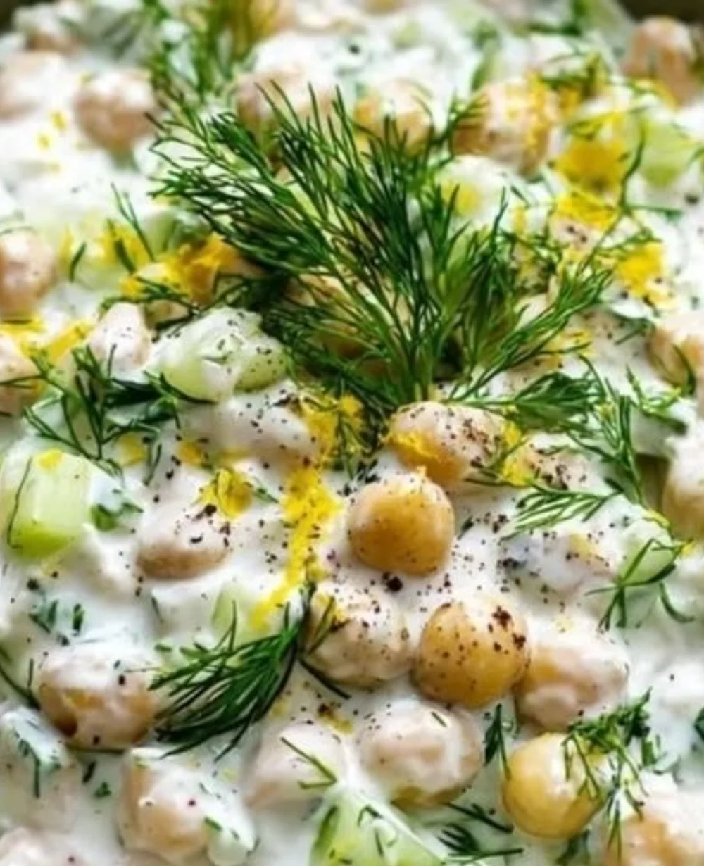Tzatziki chickpea salad with fresh vegetables and herbs in a bowl