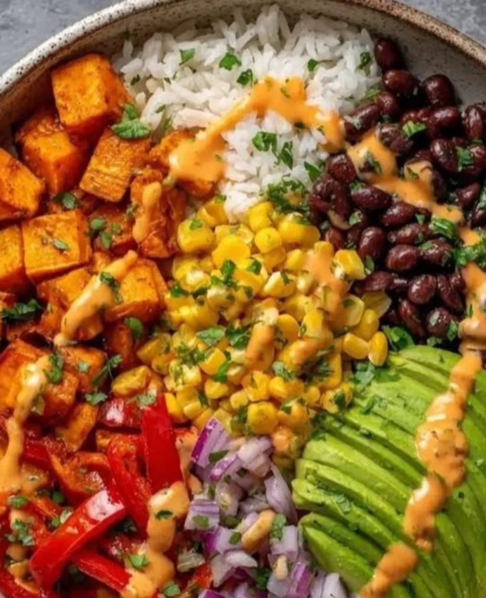 Vegan Sweet Potato Burrito Bowl topped with fresh ingredients